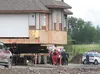 A single patient is loaded into LifeMed after being crushed underneath the dollies being used to move a house down Trunk Road Monday afternoon. The accident occured between Tern Drive and For