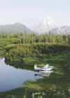 A Cessna 185 owned by Scott and Karis Johannnes floats on a lake
near Mount Redoubt. The plane crashed and sank into Cook Inlet July
24 with four people on board. All survived unharmed. (Cour