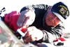 Emery Friend, who goes by the nickname "Chip," leans over a
customer's windshield earlier this week. He uses drills,
acrylic-acid epoxy and mending apparatus to fix major windshield
cracks, d