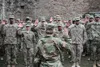 Col. Michelle M.T. Letcher, commander of the 16th Sustainment Brigade, administers the oath of reenlistment to 53 Soldiers during a mass reenlistment ceremony in Kusel, Germany. More than 80%