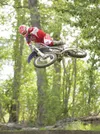 ROBERT DeBERRY/FrontiersmanAaron Loyer lays the bike flat as he
clears a double jump during a practice run Saturday at Rival
Motocross Park in the Butte.