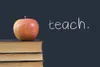 "teach" written on blackboard with apple and books Deborah Reny