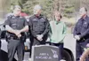 ANDREW WELLNER/Frontiersman Palmer Police Officer Philip Krauss,
left, and Cmdr. Tom Remaley, second from left, stand at Officer Jim
Rowland’s grave with the department’s chaplain, Tom Hoffma