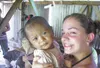 Photo Courtesy of Tara Moore Brandi Woodward of Burchell High
bonds with a Mayan child at a village in Belize. Woodward joined 14
other students on a 12-day scientific and cultural trip this
