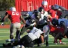 Colony's Marcus Lorentz (4), Cooper Sant (56) and Isaiah Christy (72) work to bring down Wasilla's Aeron Milliron during a 50-0 win over the Warriors Friday, Sept. 9, 2016, at Wasilla High. C