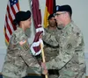 Col. Stephen Tanner, Dental Health Command Europe Commander, passes the unit colors to Master Sgt. (P) Tres Bien Adams during an Assumption of Responsibility Ceremony, Sept. 28, 2018 at Semba
