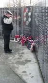 A member of the Veterans of Foreign Wars Post 33 lays a wreath
and salutes at the Veterans' Wall of Honor Thursday. Photo by CASEY
RESSLER/Frontiersman.