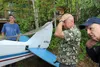 Tim Delph, center, assesses the damage to his Super Cub following a plane crash near Bogard Road in Wasilla Thursday evening. JACOB MANN/Frontiersman