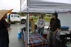 Kyndle Kirby and Aaron Christiansen work throughout the day at the Friday Fling marketplace in downtown Palmer to raise money for college. Jacob Mann/Frontiersman