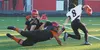 Eielson quarterback Jerimiah Brown narrowly escapes the sack attempt of Houston's Tim Sasiu during the first half of Friday night's game in Houston. MATT HICKMAN/Frontiersman