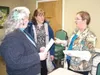 Wasilla City Councilwoman Dianne Woodruff, center, and WASI
member Anne Kilkenny, left, talk to WASI board member Katie Carney
after Thursday’s board meeting. (K.T. McKEE/Frontiersman)