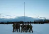 U.S. Airmen with the 673d Communications Squadron pause for a photo in front of the 120-foot tall High Frequency Global Communications System antenna tower at Joint Base Elmendorf-Richardson,