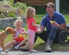 Palmer resident Cameron Schneider enjoys a snowcone outside the Palmer Museum and Visitor Center with his daughters Kayden, age 4, left, and Bradie, age 2, at the 2016 Colony Days. Frontiersm