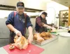 Kurt Jarmer, left, and Pat Maurin carve turkeys for tomorrow's
Christmas Friendship Dinner. (ROBERT DeBERRY/Frontiersman)