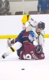Alaska defenseman Jake Parenteau takes Fairbanks forward Sean
O’Rouke down to the ice during the third period of last Friday’s
first-round playoff game at the Curtis C. Menard II memorial ice
