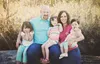 Tyson and Amy Marino smile for a photo with their daughters: Faith (left), Carlie (center) and Aria. The Marinos recently adopted Carlie after fostering her for two years. Photo by Relic Phot