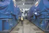 In this file photo from 2013, Tony Zellers, director of the Eklutna Generation Station Project, walks between two of the 19-foot-tall, 65-foot-wide and 390-ton Wartsila engines that will powe