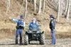 (ROBERT DeBERRY/Frontiersman) Lynn Sandvik, center, talks with
Alaska State Troopers at the scene of a controlled fire that got
out of control. Sandvik was burning a pile of logs on his prope