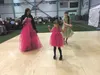 Brandi Kinney dances with daughter Amithist Kinney (matching pink ball gowns) and Elilana Overstreet at the Wasilla Centennial Ball held at the Menard Sports Center on Saturday. MARY LOCKMAN/