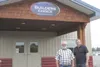 Builders Choice plant manager Vaughn Nadeau and Builders Choice President and owner Mark Larson stand in front of the Meadow Lakes plant last month. HEATHER A. RESZ/Frontiersman