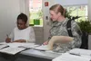 Right, Maj. Bridget Dalziel receives assistance July 23 from JBM-HH Military Personnel Division Out Processing Lead Christine Aikens, with PCS orders to Fort Eustis in Newport News, Va. Dalzi