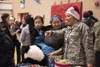 The children of St. Michael visit with volunteers and Alaska National Guard members during Operation Santa Claus on Dec. 5, 2017. Operation Santa Claus is an Alaska National Guard annual comm