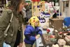 Tiernan Murdock admires a couple of Juliet Bartolo's 'Wee Woolies' felted sculptures with his grandma at the Colony High School Christmas Bazaar on Saturday. Nov. 28. The 21st annual bazaar b