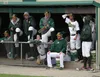 Members of the Mat-Su Miners line the front of the dugout late in the game Monday. JEREMIAH BARTZ/ Frontiersman