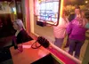 Denise Dunnigan sits inside the Palmer Bar Thursday as bar patrons smoke cigarettes outside. An initiative Palmer voters passed in October 2012 prohibits smoking in public places, such as the