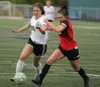 Colony's Sahara Iverson and Kenai's Kennedy Daniels run to the ball during Colony's 1-0 win over the Kardinals during the Northern Lights Conference girls' semifinals Friday at Colony High. J