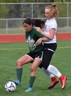 Colony's Kira Fagerstrom (left) battles for possession against Kenai Central's Liz Hanson in a consolation semifinal Friday at the girls state soccer tournament at Eagle River High School. Jo