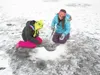 Larson Elementary School students Brooklyn Osgood and Melissa Escobedo try to hook a fish recently while fishing through the ice of Finger Lake. Courtesy photo Stacy Escobedo