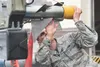 Airman 1st Class Emmanuel Pena, a 525th Aircraft Maintenance Unit weapons loader, checks over a munition for loading during the Wing Weapons Load Crew 1st Quarter Competition May 18, 2018, at