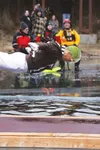WASILLA — A member of the Country Legends 100.9 fundraising team plunges into the frigid waters of Wasilla Lake Friday during the 11th Annual Mat-Su Plunge. This year’s edition of the Mat-Su 