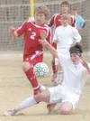 Wasilla sophomore Aaron Sharrow, left, tries to move past a
sliding Bridger Van Ness during the Warriors’ 5-1 win over Colony
at Colony High School on Tuesday. Sharrow notched assists on each