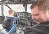 Joe Pratt, Wasilla, and his 7-year-old son, Daniel, enjoy some time at the controls of a former Marine Corps C-119 named 'Rolling Boxcar' at the Airman's Gathering. J. David McChesney/Frontie
