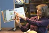 Swanson Elementary School librarian Kim Evans points to an illustration in 'The Shelf Elf,' which she read to students on Tuesday, Jan. 5. Swanson was recently selected as one of 467 winners 