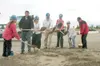 Officials turn the first shovels of dirt while breaking ground
at the site of the new South Palmer Elementary School.