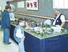 Marty Quaas shows off the town of Mooselip at Palmer Colony Days
recently. Mooselip is a railroad-based fictitious town that has
very detailed scenarios, such as boys pushing over an outhouse