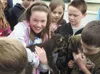 Sherrod third-grader Keely Livingston is all smiles as she holds
one of Lee Hecimovich’s young male lambs that visited the school
for Alaska Agriculture Day on May 3. To the right of Keely ar