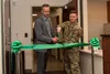 Matt Clugston (left), federal healthcare program manager with Walsh Construction, and U.S. Air Force Tech. Sgt. Sean Connors, 673d Surgical Operations Squadron MRI technologist, cut the ribbo