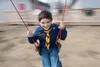 Boy Scout Troop 338 member Tanner James, 9, takes his turn on the merry-go-round swing at the 17th annual Scout-O-Rama at Wasilla High School Saturday afternoon. ROBERT DeBERRY/Frontiersman.c