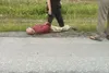 An unidentified male lays handcuffed along the Parks Highway Monday afternoon as a Wasilla Police Department officer stands above him. Wasilla Police and the Alaska State Troopers responded t