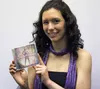 Palmer High School senior Emily Yannatone smiles for a photo with her debut album, 'Supernova,' released on iTunes, Amazon and Google Play on April 5. CAITLIN SKVORC/Frontiersman.com