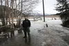 Chris Loscar is pictured standing in the driveway in front of his garage Wednesday. Melting snow is traversing from the field behind him and causing headaches for not only him, but several ne