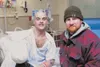 John Buckley and Robert DeBerry pose for a photograph inside
Buckley's hospital room at Mat-Su Regional Medical Center. Buckley
lost part of his right arm in an industrial accident outside th