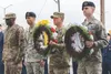 U.S. Air Force and Army service members hold a wreath at a memorial ceremony during Police Week at Joint Base Elmendorf-Richardson, Alaska, May 18, 2018. The ceremony highlighted the sacrific