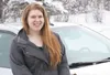 Emerald Kroeker stands for a photo in front of the vehicle she was driving when Alaska State Troopers pulled her over for weaving, and subsequently ticketed her for texting while driving. HEA