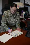 Senior Master Sgt. Karen Jakubczak, 673d Force Support Squadron career assistance Advisor, signs certificates of completion of the FTAC Airman Course June 3, 2019, at Joint Base Elmendorf-Ric