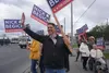 Republican Nick Begich waves at motorists passing through Midtown Anchorage during rush hour on Aug. 16. Begich is one of three listed candidates competing in the state's first ranked-choice 